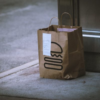 brown paper bag on gray concrete floor