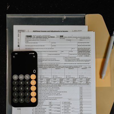 Calculator and pen on tax forms